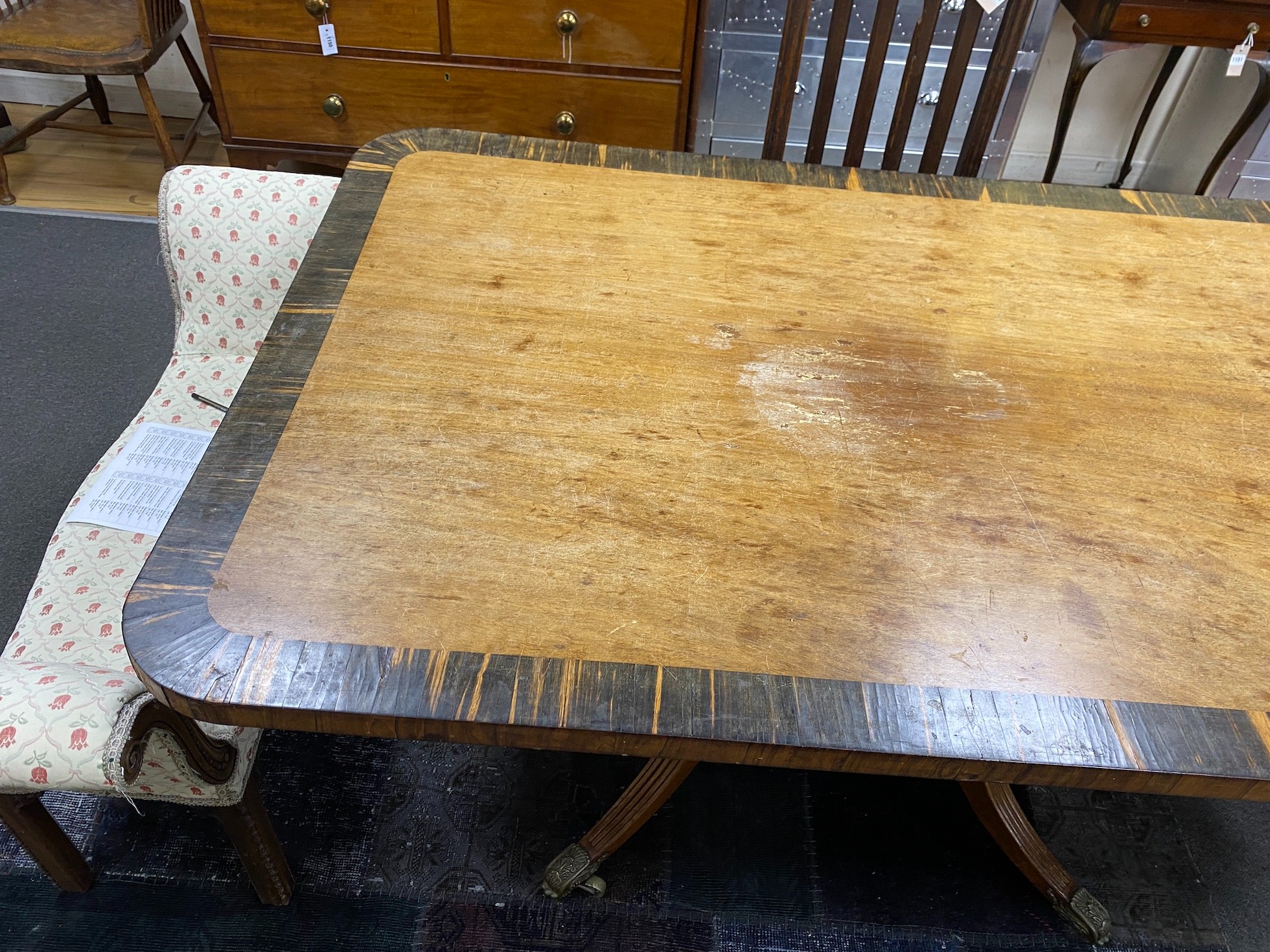 A Regency coromandel banded rectangular mahogany tilt top dining table, length 160cm, width 106cm, height 74cm